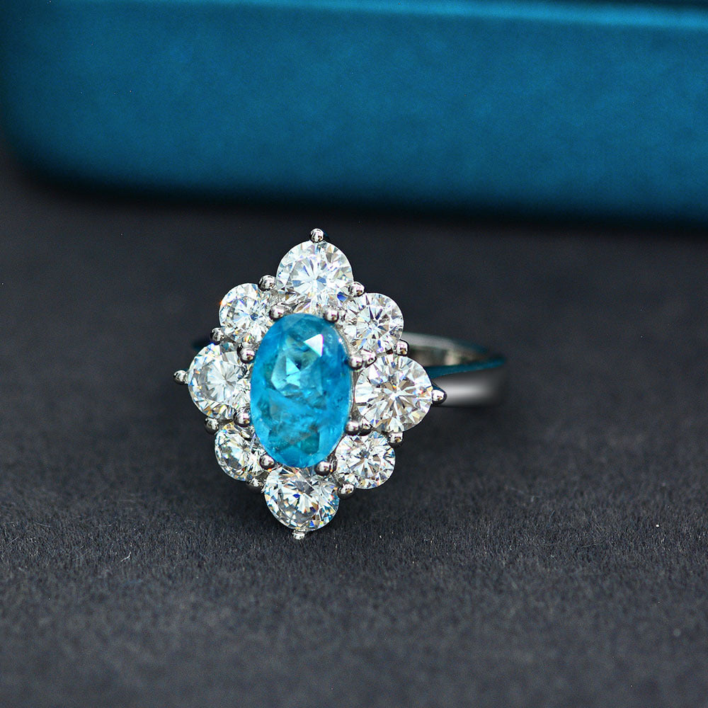 Oval shaped Paraíba blue sapphire set with cubic zirconia in a 925 sterling silver halo Ring