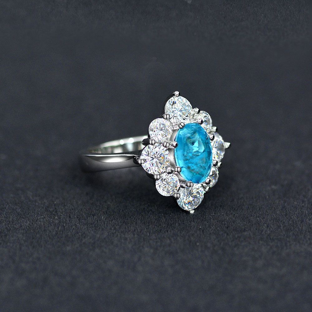 Oval shaped Paraíba blue sapphire set with cubic zirconia in a 925 sterling silver halo Ring